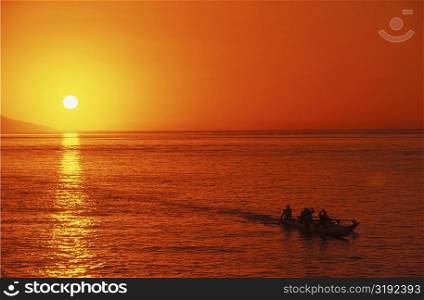 Silhouette of a group of people on a boat in the ocean, Hawaii, USA