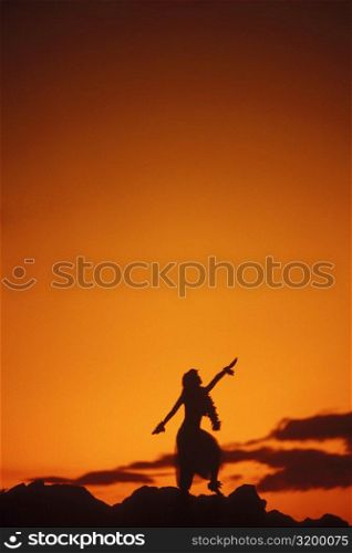 Silhouette of a Hawaiian hula dancer dancing on the beach, Hawaii, USA