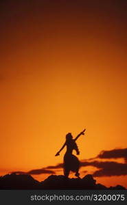 Silhouette of a Hawaiian hula dancer dancing on the beach, Hawaii, USA