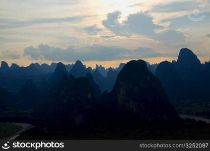 Silhouette of a hill range at dusk, Guilin Hills, XingPing, Yangshuo, Guangxi Province, China