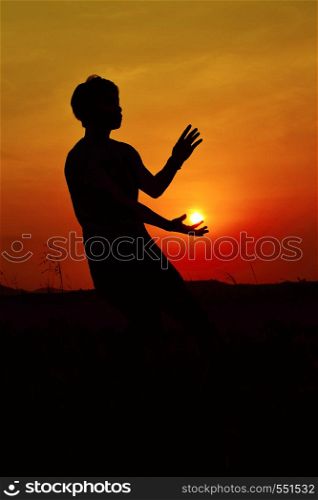 Silhouette of a Hip Hop Dancer posing near mountain at sunset, Pune, Maharashtra.