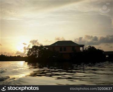 Silhouette of a house at the riverside