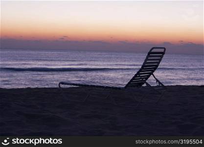 Silhouette of a lounge chair on the beach, Miami, Florida, USA