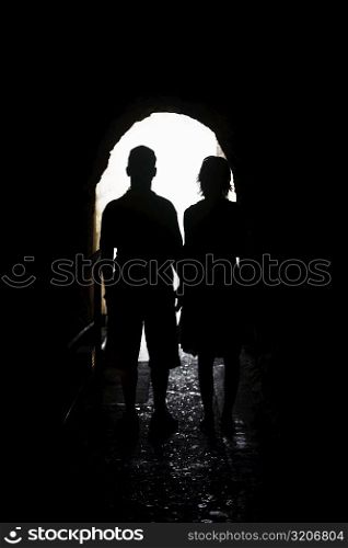 Silhouette of a man and a woman standing in an archway, Diamond Head, Waikiki Beach, Honolulu, Oahu, Hawaii Islands, USA