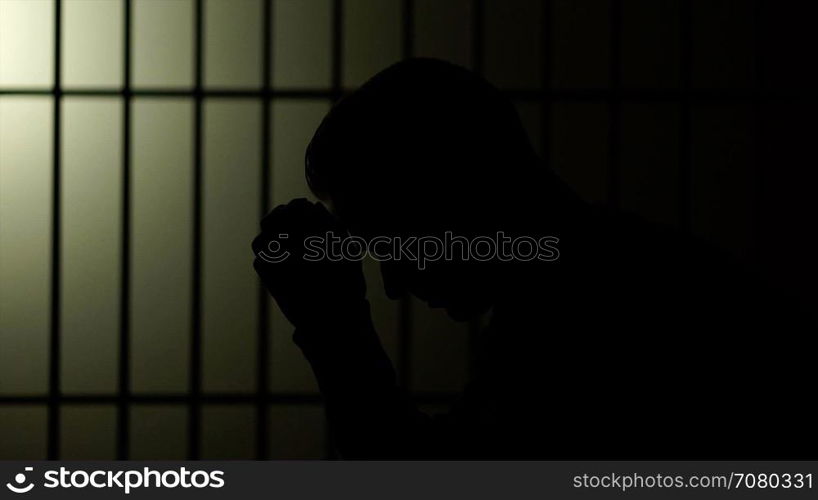 Silhouette of a man in prison