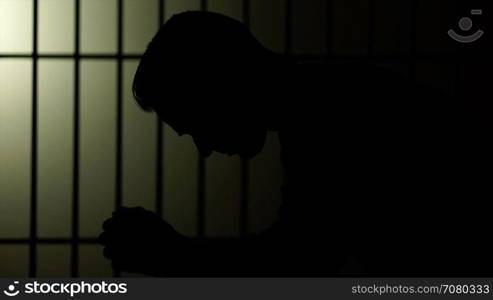 Silhouette of a man in prison