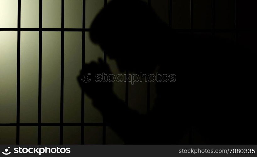 Silhouette of a man in prison