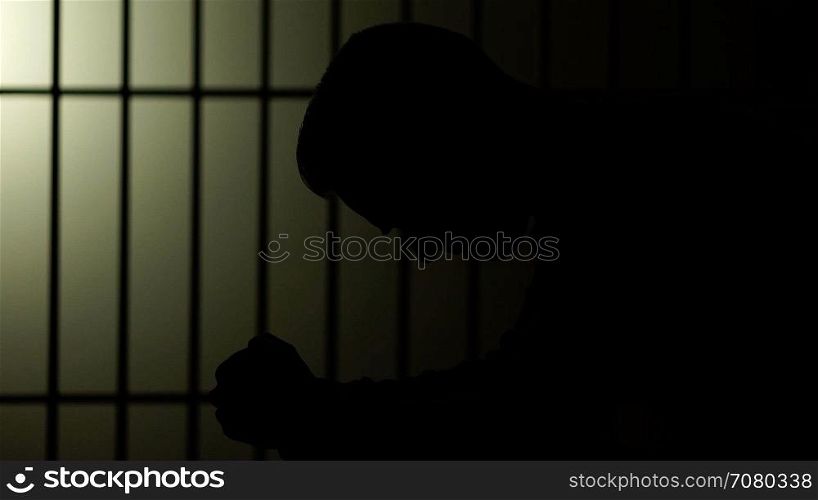 Silhouette of a man in prison