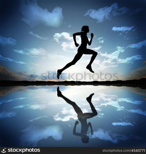 Silhouette of a man running against the evening sky