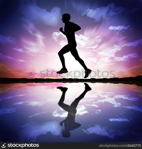 Silhouette of a man running against the evening sky