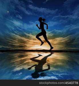 Silhouette of a man running against the evening sky