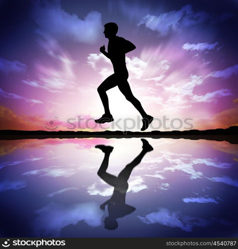 Silhouette of a man running against the evening sky