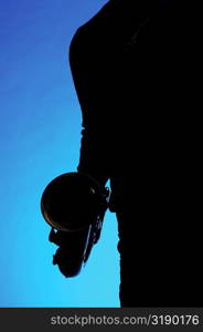 Silhouette of a musician holding a saxophone