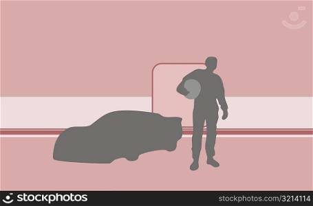 Silhouette of a person standing near a racecar