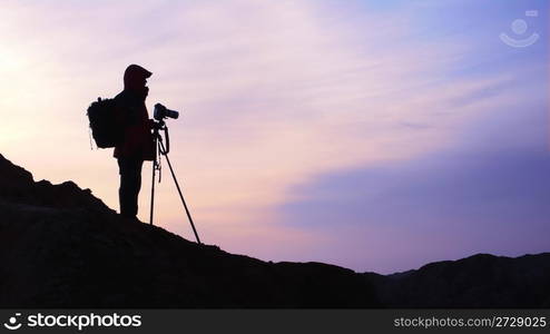 Silhouette of a photographer at sunrise