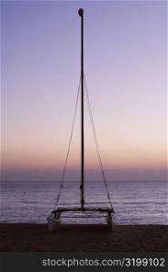 Silhouette of a sailboat on the beach