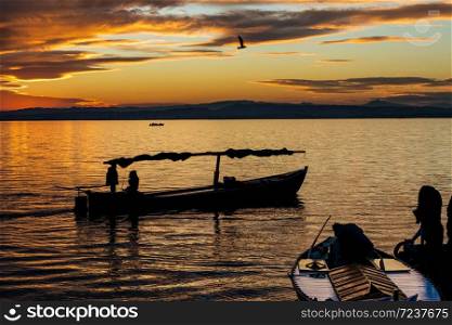 Silhouette of a small traditional boat at dusk in the Albufera in Valencia, a freshwater lagoon and estuary in Eastern Spain.