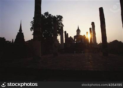 Silhouette of a statue of Buddha in a temple, Wat Mahathat, Sukhothai Historical Park, Sukhothai, Thailand