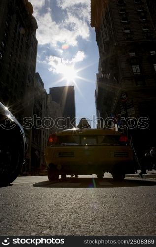 Silhouette of a taxi on the road in a city