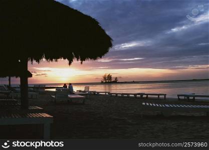 Silhouette of a thatched canopy is seen at Negril Beach, Jamaica