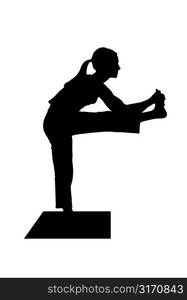 Silhouette Of A Woman Posing On A Yoga Mat