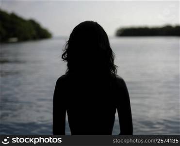 Silhouette of a young woman by the sea
