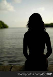 Silhouette of a young woman by the sea