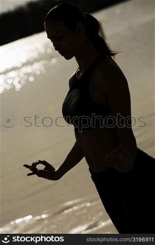 Silhouette of a young woman practicing martial arts