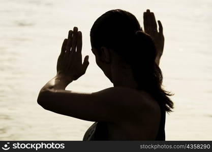 Silhouette of a young woman practicing martial arts