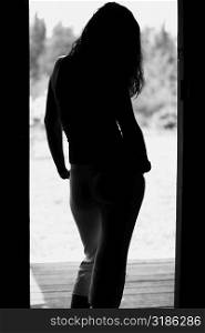 Silhouette of a young woman standing