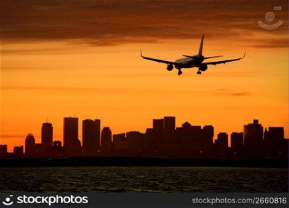 Silhouette of aircraft and cityscape