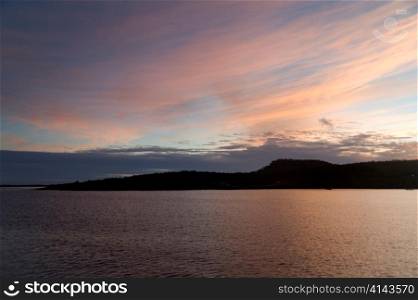 Silhouette of an island at dusk, Puerto Baquerizo Moreno, San Cristobal Island, Galapagos Islands, Ecuador