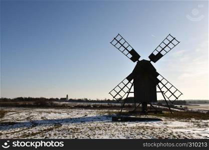 Silhouette of an old wooden windmill in winter season at the swedish island Oland