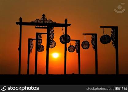 Silhouette of beach decorations on a scenic Indonesian tropical island at sunset