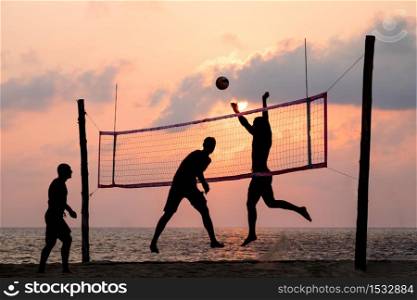 silhouette of beach Volleyball player on the beach and playground sand in sunset