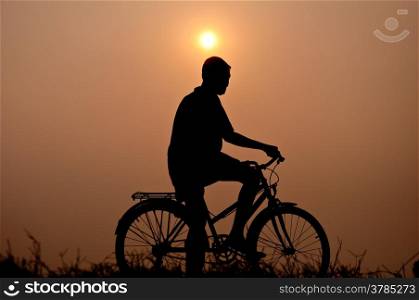 silhouette of boy riding bicycle for health