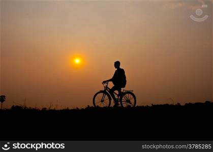 silhouette of boy riding bicycle for health