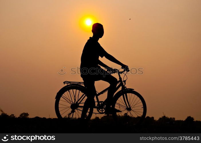 silhouette of boy riding bicycle for health