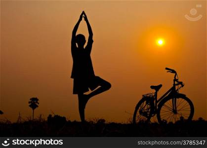 silhouette of boy Yoga with bicycle