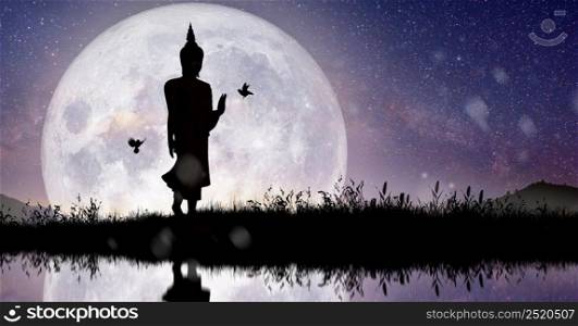 Silhouette of Buddha mediating with Full moon light at night. Magha Puja, Asanha Puja, and Visakha Puja Day. Buddhist holiday Concept.