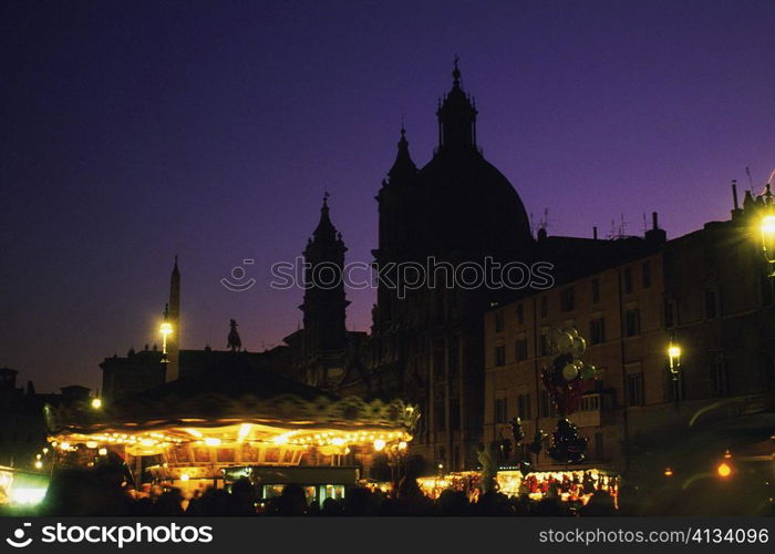 Silhouette of buildings lit up at night, Rome, Italy