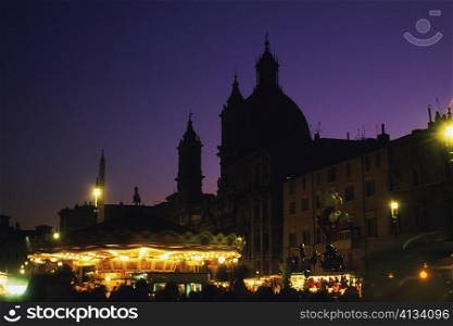 Silhouette of buildings lit up at night, Rome, Italy