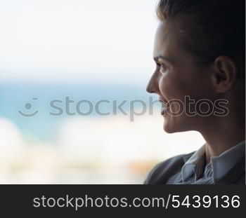 Silhouette of business woman looking into window