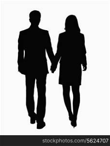Silhouette of businessman and businesswoman holding hands.