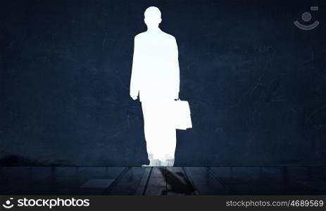 Silhouette of businessman in wall. Dark wall and silhouette of businessman as doorway