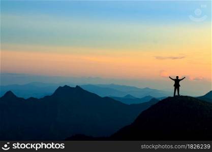 silhouette of businessman on mountain top over sunset sky background, business, success, leadership and achievement concept