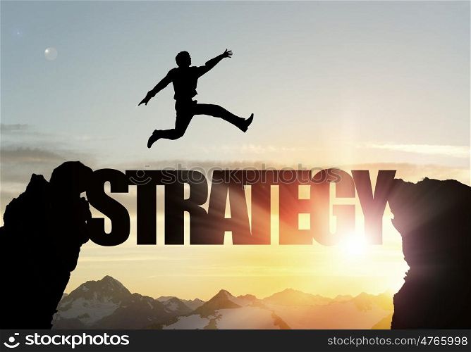 Silhouette of businessman over sunrise. Businessman running on strategy word bridge over precipice
