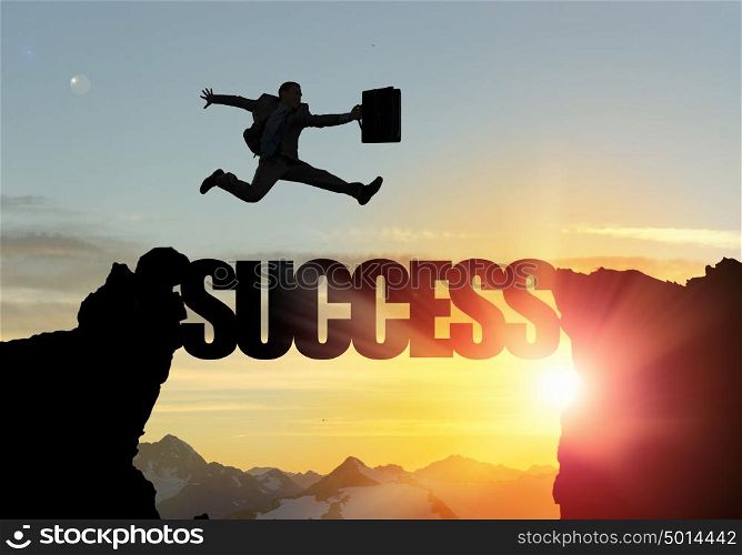 Silhouette of businessman over sunrise. Businessman running on success word bridge over precipice