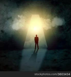 Silhouette of businessman standing in keyhole sun shining above