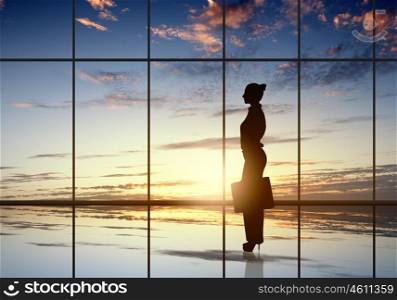 Silhouette of businesswoman. Silhouette of businesswoman against panoramic office window